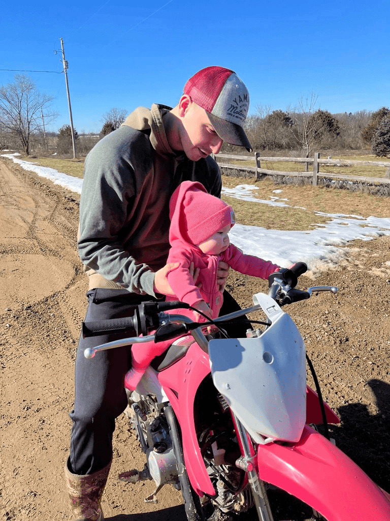 Luke Vasilion with his daughter on a dirt bike